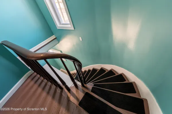 a view of a hallway and an empty room with a window