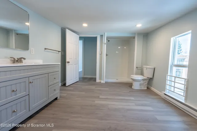 a kitchen with stainless steel appliances granite countertop a refrigerator a sink dishwasher a stove and a microwave oven on granite countertops