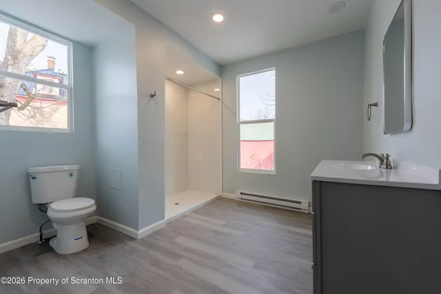 a bathroom with a shower and a toilet