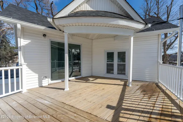 a view of a balcony with wooden floor