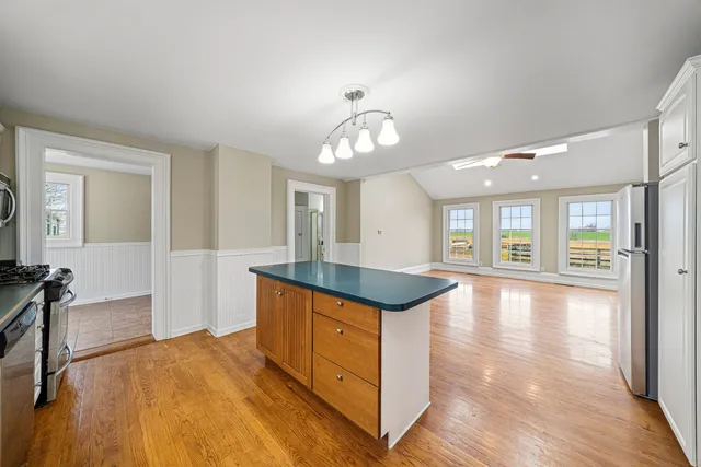 a view of an empty room and window and wooden floor