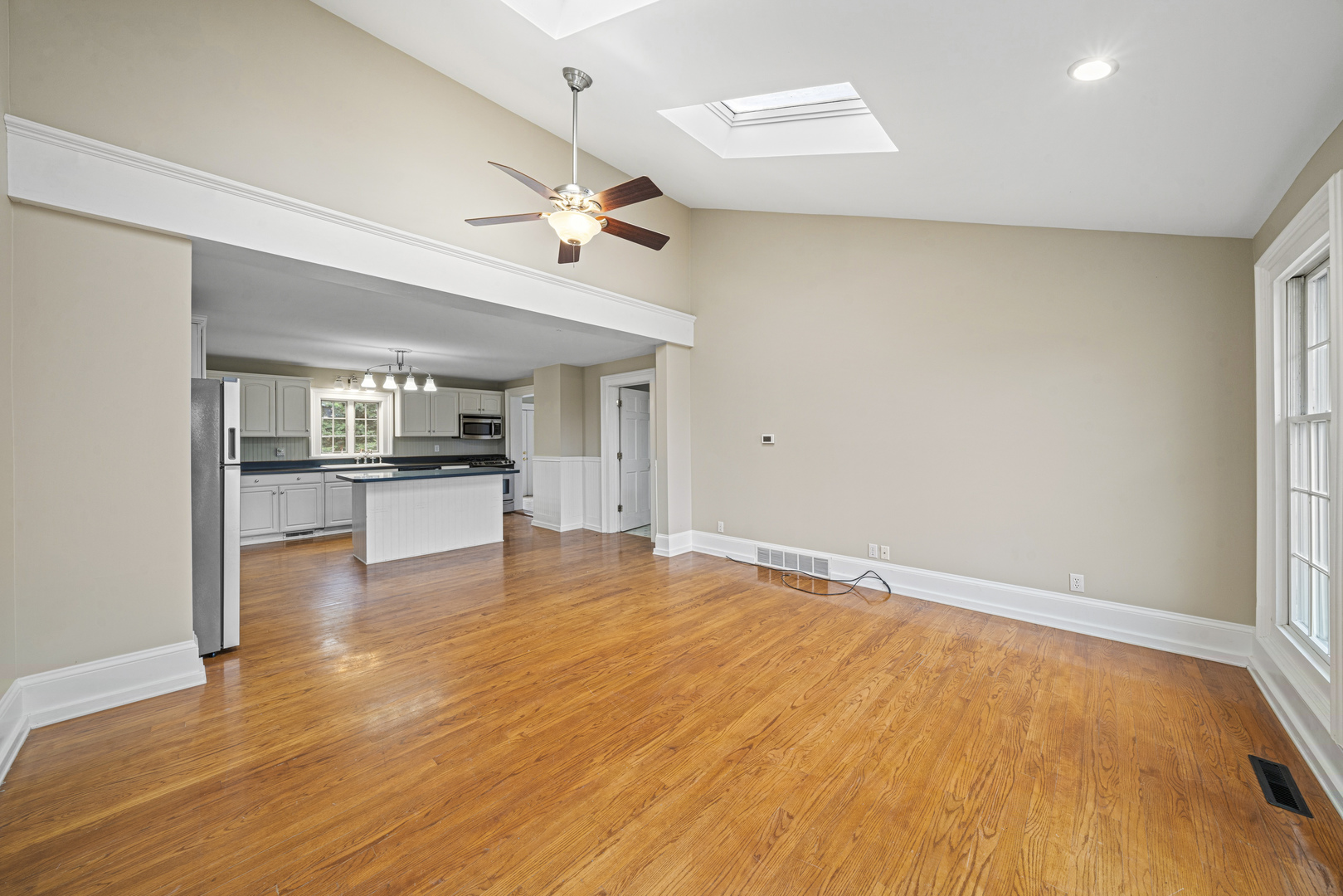 16645 Lasher Road Hinckley, IL 60520 - Photo 15 of 80 a view of empty room with wooden floor and kitchen view