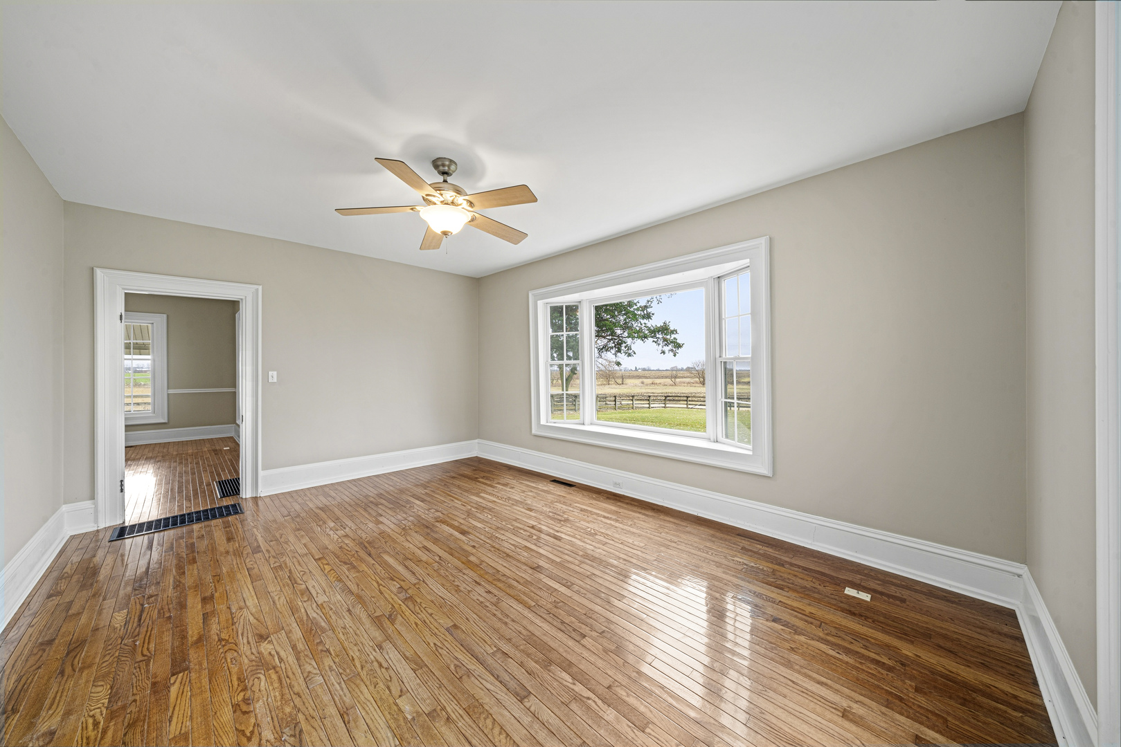 16645 Lasher Road Hinckley, IL 60520 - Photo 16 of 80 a view of an empty room and window and wooden floor
