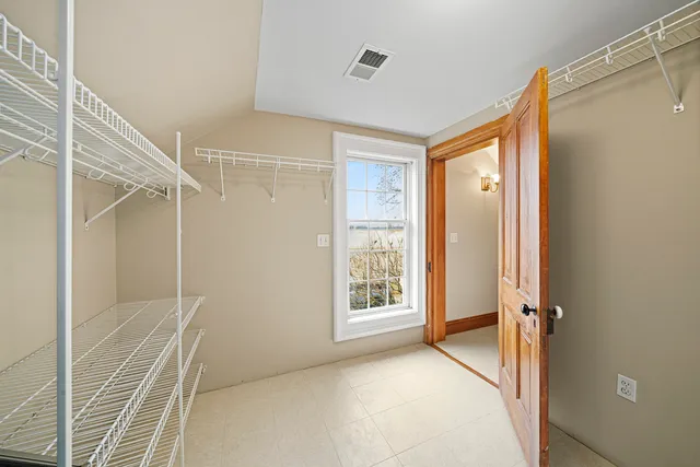 an empty room with wooden floor and closet