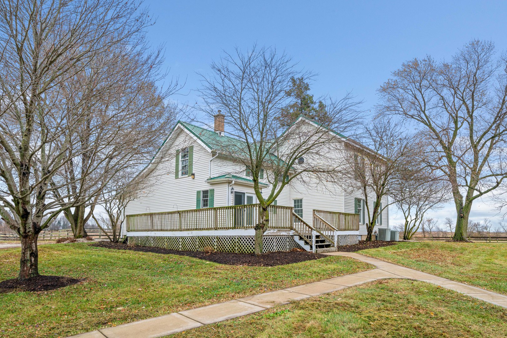 16645 Lasher Road Hinckley, IL 60520 - Photo 38 of 80 a view of a white house next to a yard with a large tree