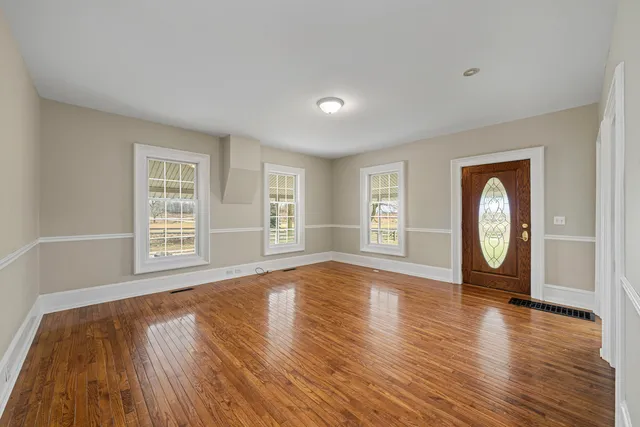 a kitchen with granite countertop a stove top oven a sink a counter space and cabinets