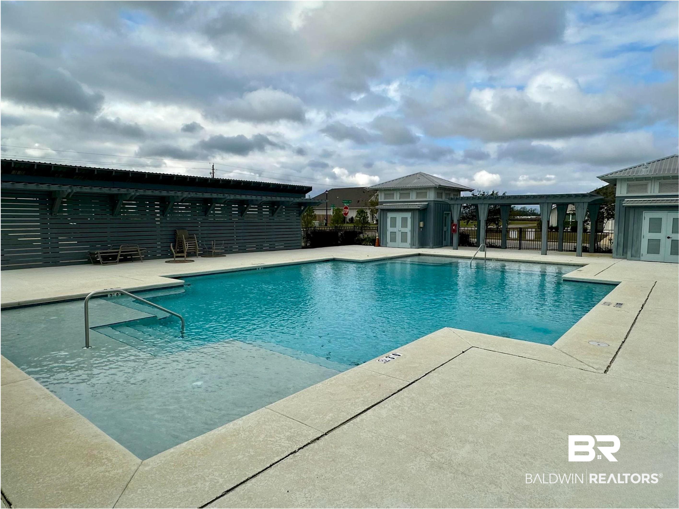 1040 Hayward Loop Foley, AL 36535 - Photo 31 of 35 Community swimming pool featuring a perimeter of concrete decking and a shallow entry area