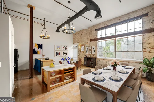 a dining room with furniture and window