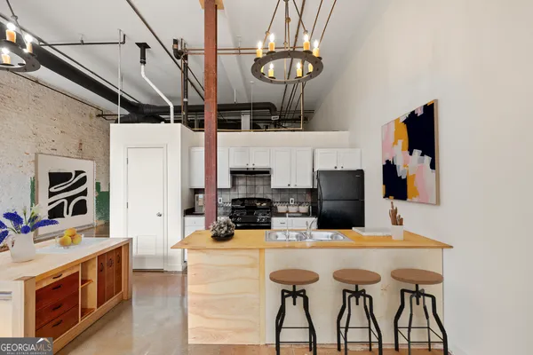 a kitchen with a cabinets a counter space and stainless steel appliances
