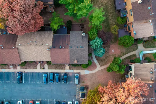 an aerial view of multiple houses with a yard