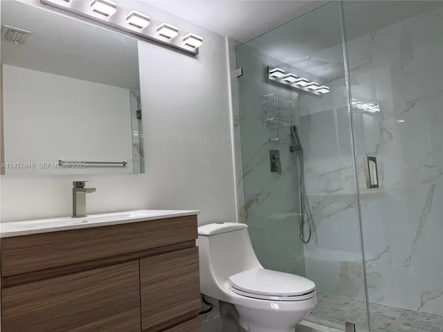 a bathroom with a toilet a sink and shower