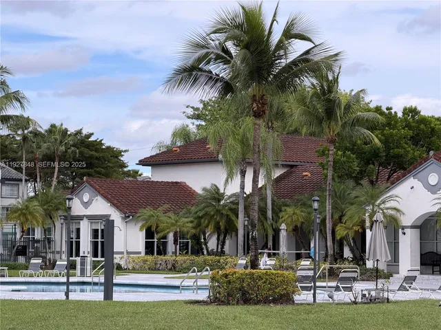 a swimming pool with outdoor seating and yard