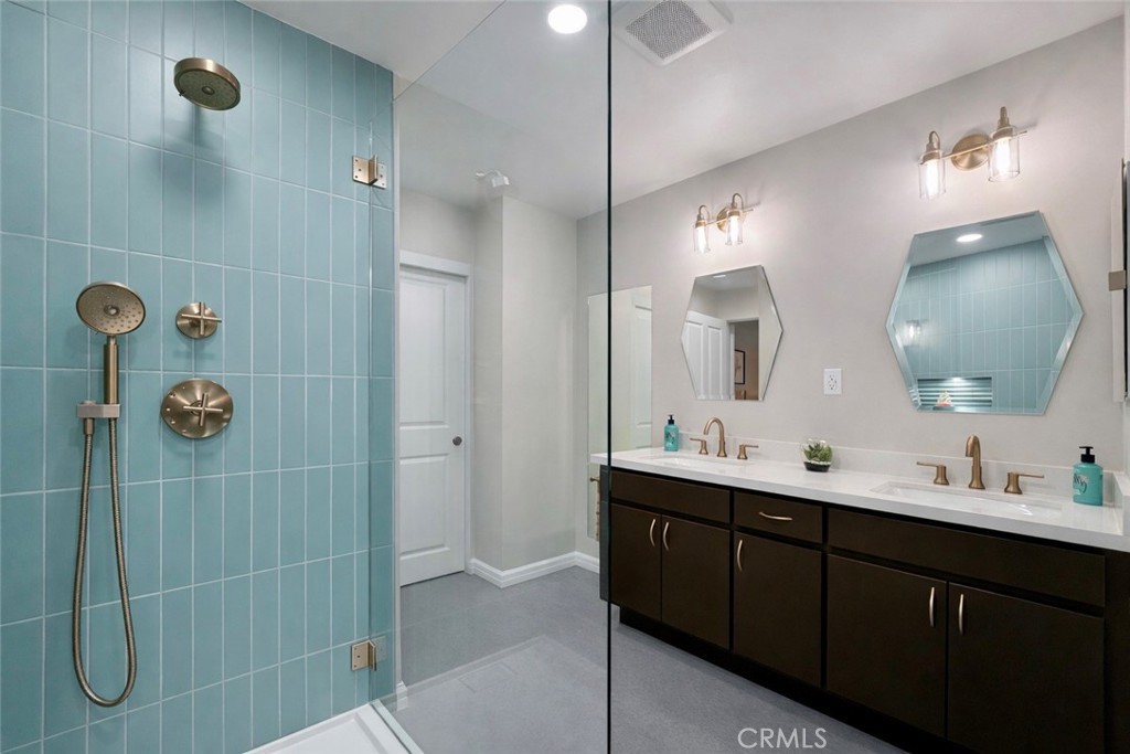 1108 18th Street, Unit 7 Santa Monica, CA 90403 - Photo 15 of 26 a bathroom with a double vanity sink mirror and shower