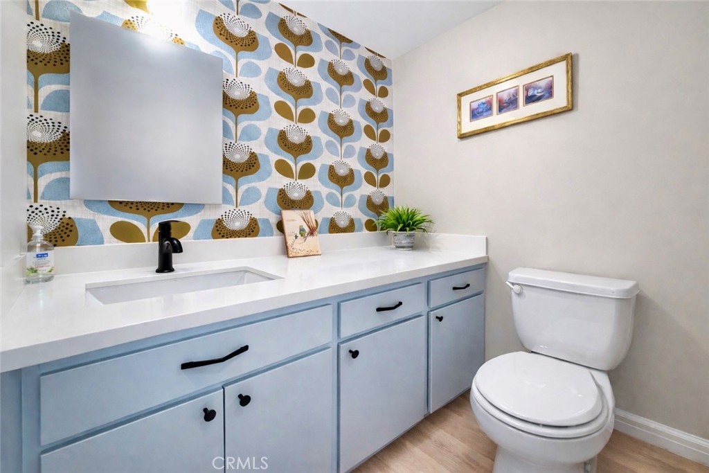 1108 18th Street, Unit 7 Santa Monica, CA 90403 - Photo 22 of 26 a bathroom with a sink a toilet and a mirror