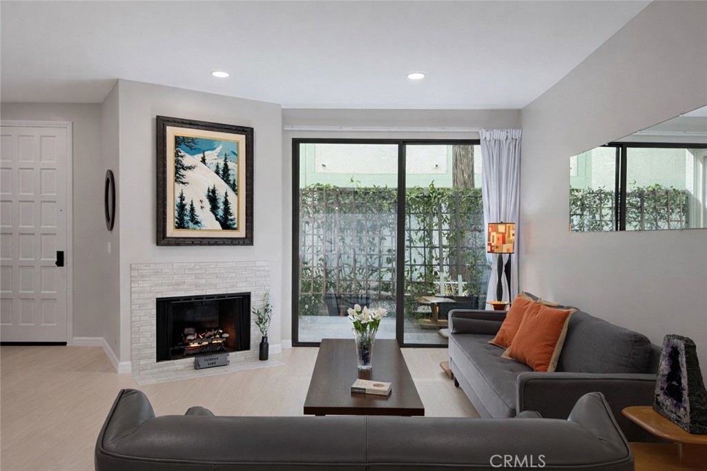 1108 18th Street, Unit 7 Santa Monica, CA 90403 - Photo 4 of 26 a living room with furniture fireplace and a large window