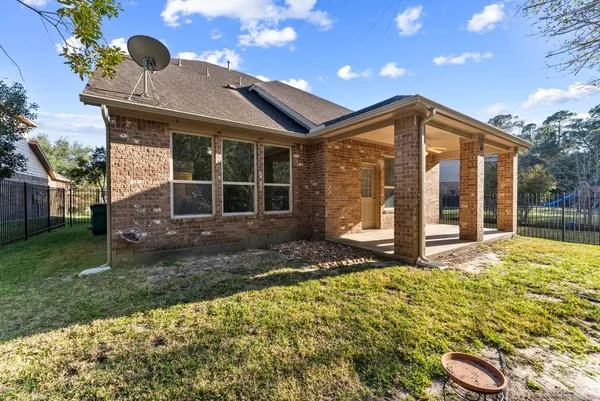 a view of a house with backyard and sitting area