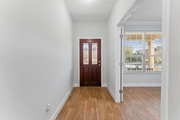 a view of a room with wooden floor and window