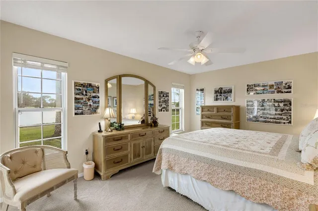 a spacious bedroom with a bed a couch and a window