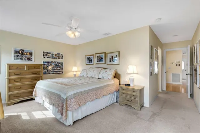 a spacious bedroom with a bed and a cabinets