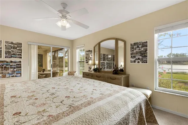 a bedroom with a large bed and a large window with outer view