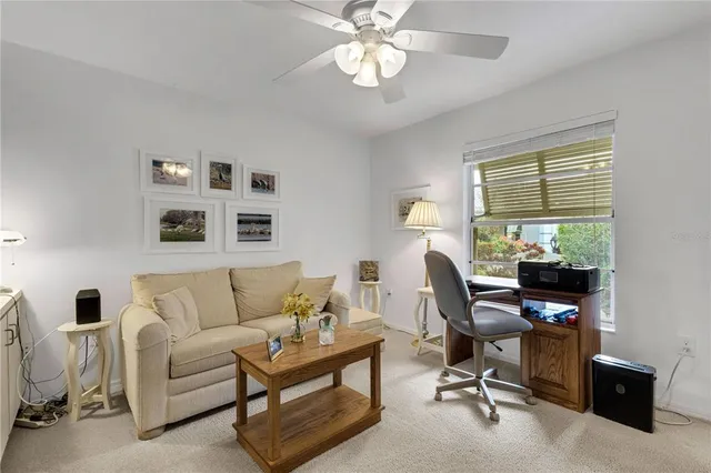 a view of a livingroom with workspace and a couch
