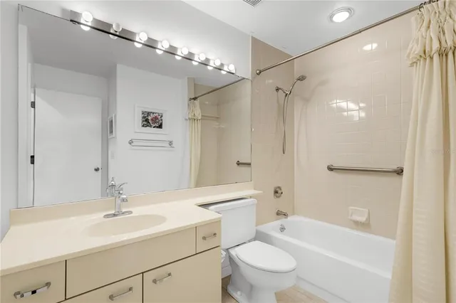 a bathroom with a sink a toilet a mirror and shower