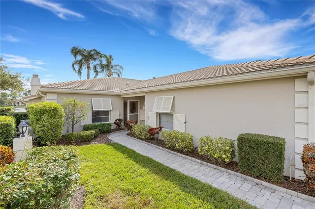 a front view of a house with a garden and patio