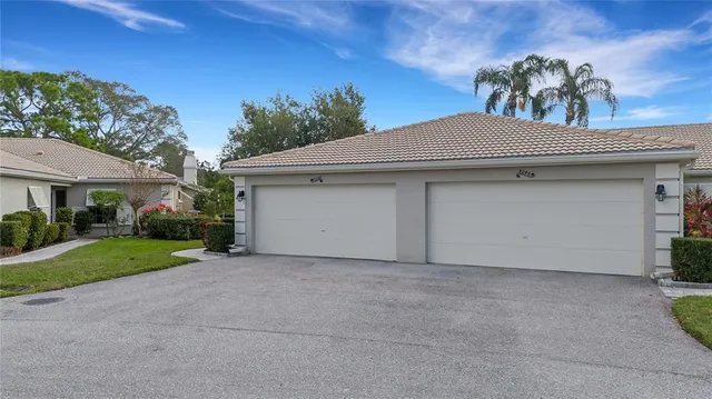 a view of a house with garage and yard