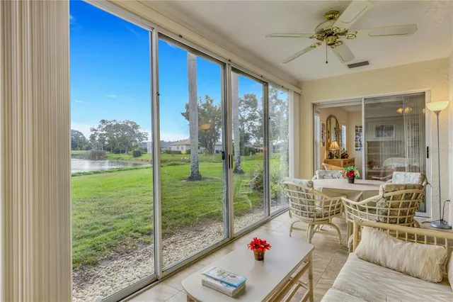 a living room with hardwood floor and a large window