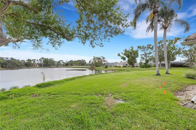a view of a lake with houses in the back