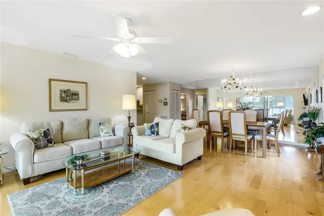 a living room with furniture and view of kitchen