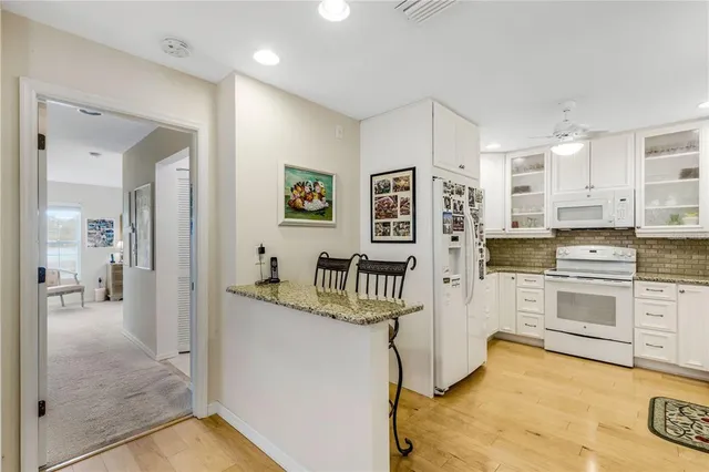 a kitchen with stainless steel appliances granite countertop a refrigerator and stove top oven