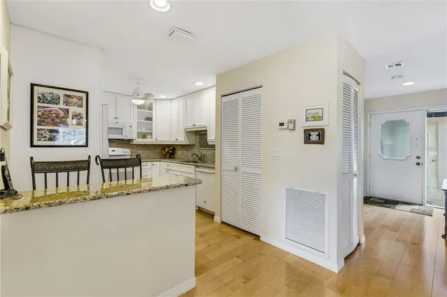 a kitchen with stainless steel appliances granite countertop a refrigerator and a sink