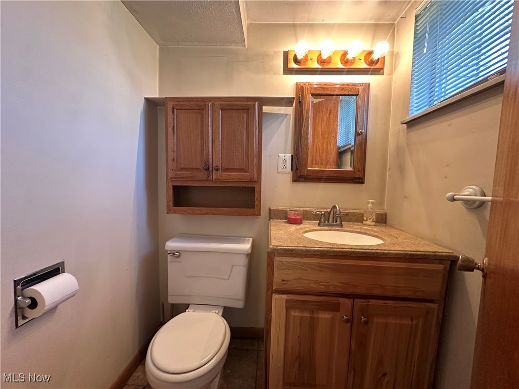2829 Shellhart Road Barberton, OH 44203 - Photo 15 of 29 Lower level half bathroom featuring toilet and vanity