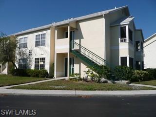 2008 Rookery Bay Drive, Unit 1102 Naples, FL 34114 - Photo 1 of 1 a front view of a house with a yard