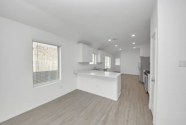 a view of kitchen with sink and wooden floor