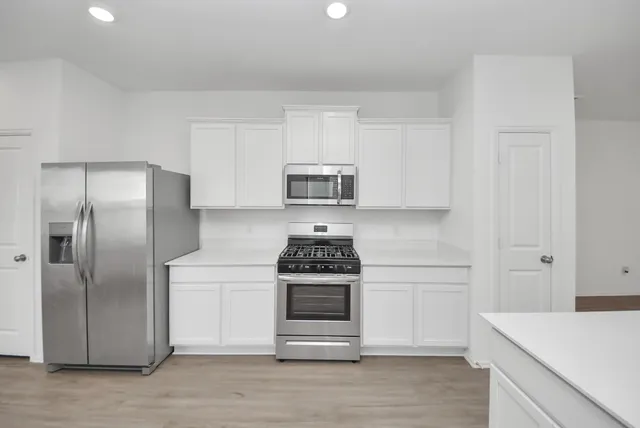a kitchen with a stove and a refrigerator