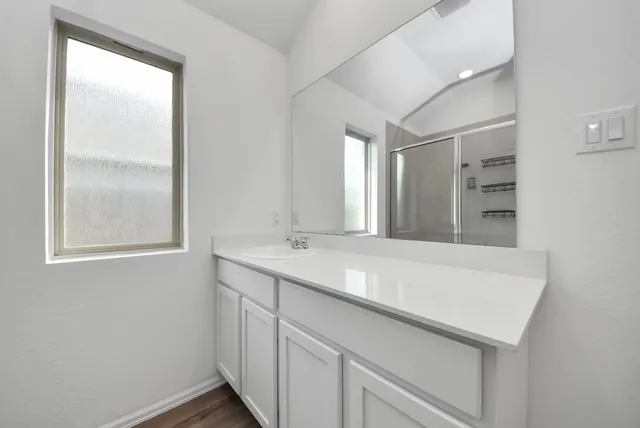 a bathroom with a sink and a window