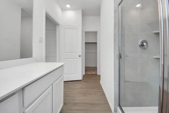 a bathroom with a shower and a sink