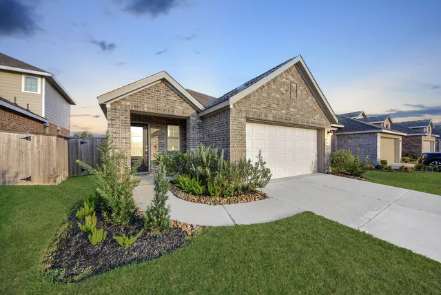 a view of a house with brick walls and garden