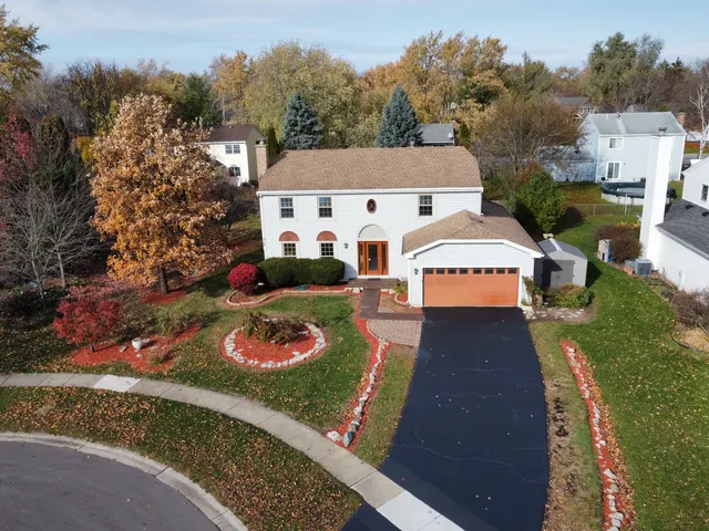 an aerial view of a house with yard