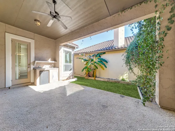 a view of a house with a yard and potted plants