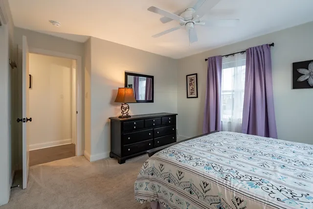 a bedroom with a bed and a dresser