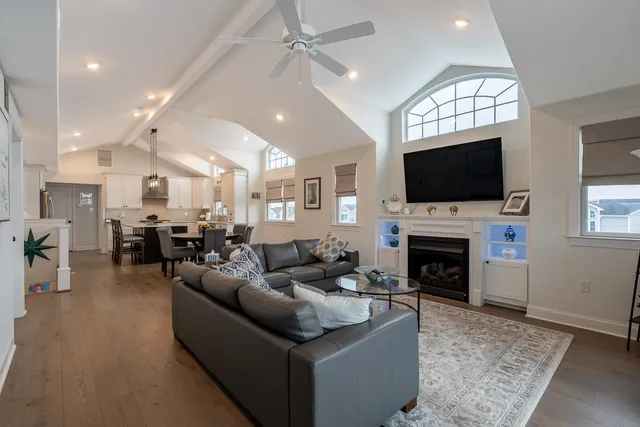 a living room with furniture a fireplace and a flat screen tv