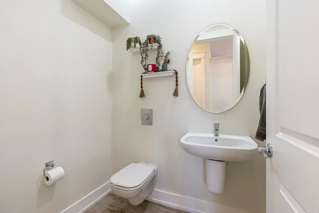 a bathroom with a sink toilet and a mirror