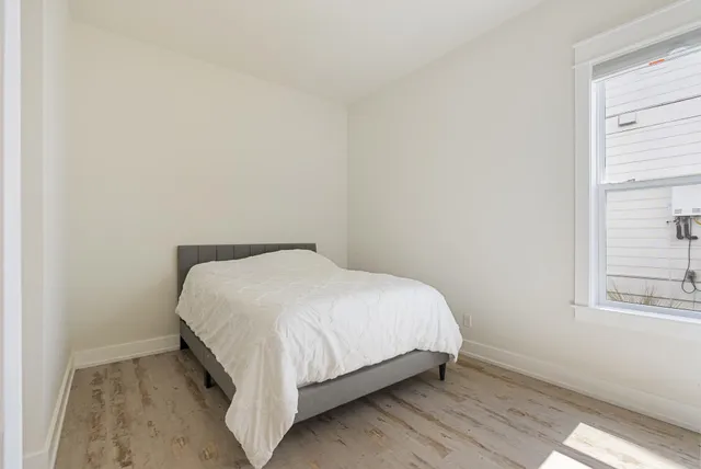 a bed sitting in a bedroom next to a window
