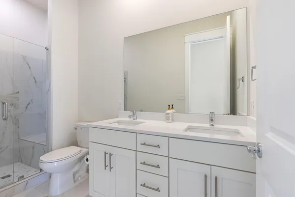 a bathroom with a toilet a sink and a mirror