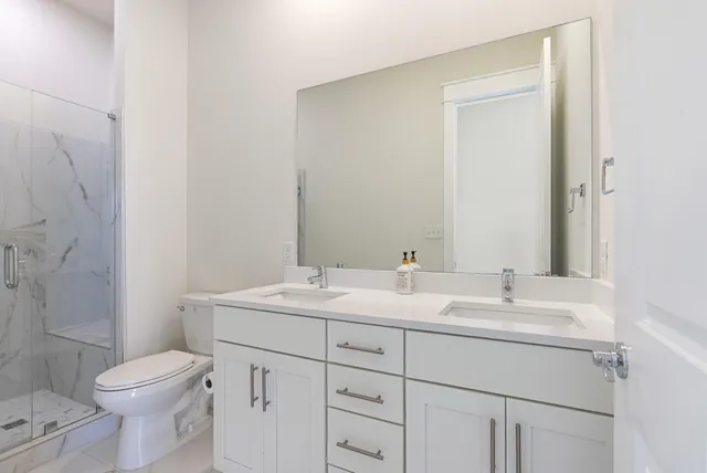 a bathroom with a toilet a sink and a mirror