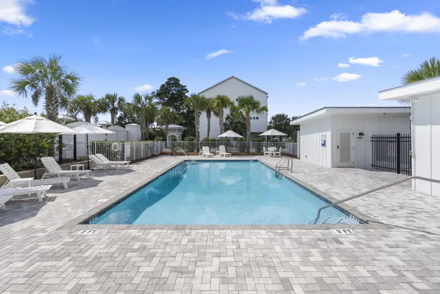 an outdoor space with swimming pool and furniture