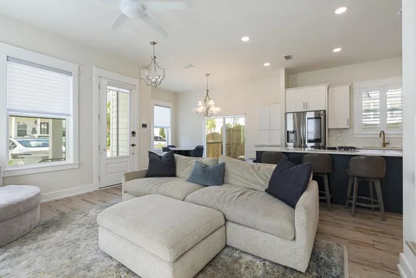 a living room with furniture a dining table and chairs
